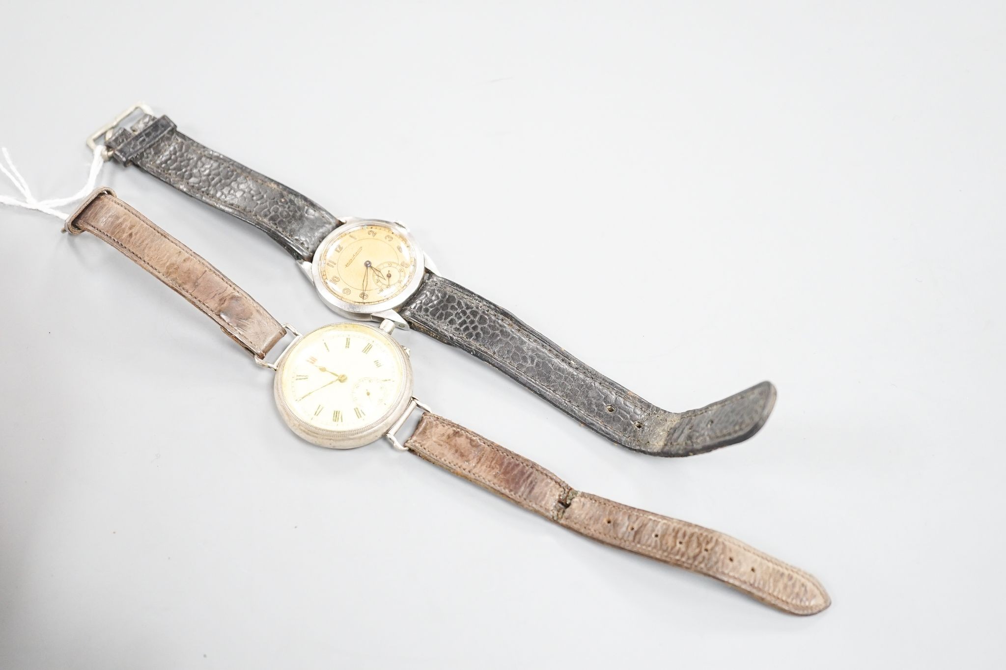 A gentleman's stainless steel Jaeger LeCoultre manual wind wrist watch, case back numbered 64765, on associated strap and a white metal fob watch, now mounted as a wrist watch(a.f.).